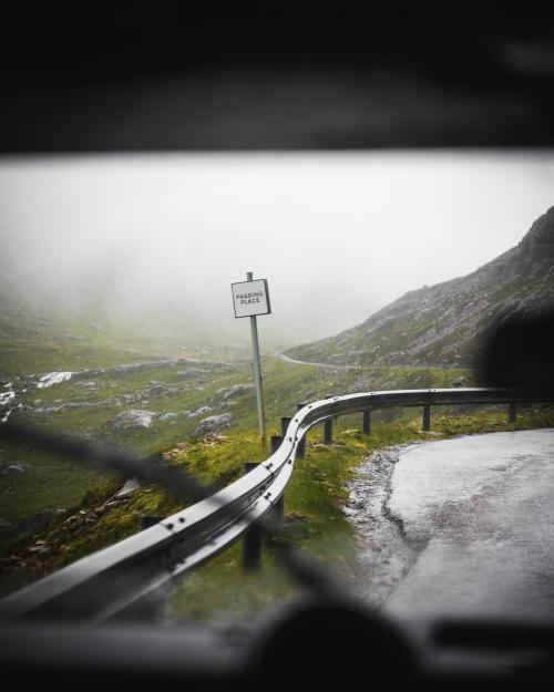 Passing place sign on a rural road in a misty day - 1204731