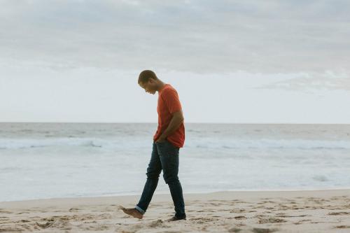 Happy man walking on the beach on a sunny day - 1079757