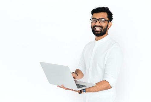 Smiling Indian guy with a computer - 6772