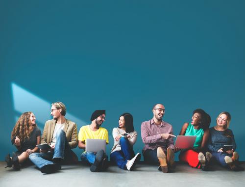 Group of diverse people in a row sitting on the floor - 6215