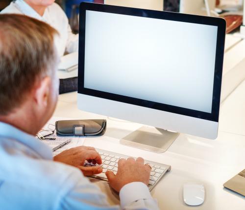 Senior man using a computer with an empty screen - 5249