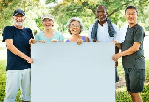 Sporty senior friends showing an empty placard - 5291