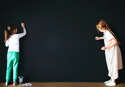 Little girls drawing on an empty wall - 5340