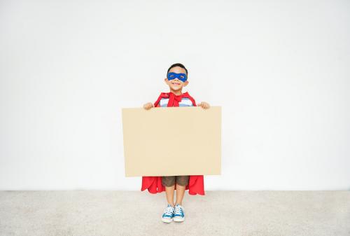 Super boy holding a mockup banner - 5341