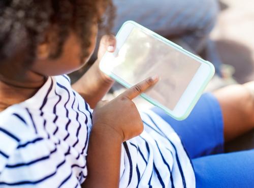 African American kid using a smartphone with a copyspace - 5374