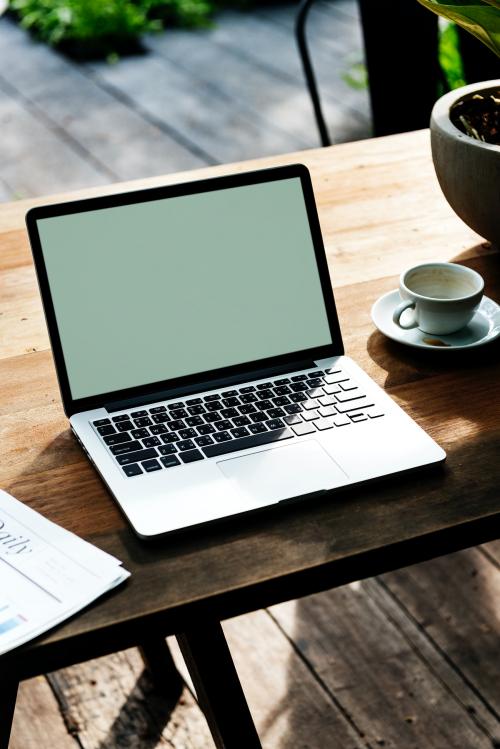 Laptop with an empty screen on a wooden table - 5442