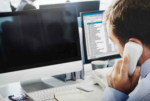 Businessman on the phone and an empty screen computer - 5486