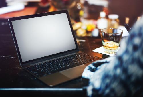 Man using an empty screen laptop in a bar - 5507