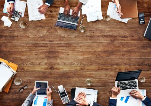 Aerial view of a table with people working on digital devices - 5606