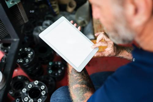 Auto Repair Shop Owner Checking Tablet Concept - 5817