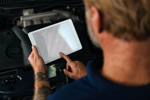 Auto Repair Shop Owner Checking Tablet Concept - 5835