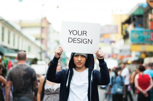 Young asian man holding empty placard outdoors - 5851