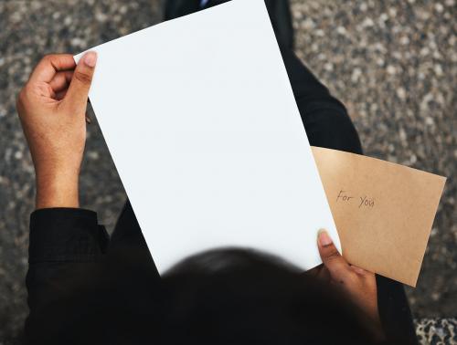 Holding a piece of blank paper mockup - 5859