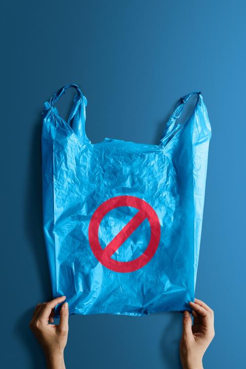 Woman holding a blue plastic bag mockup with a ban sign - 1213783