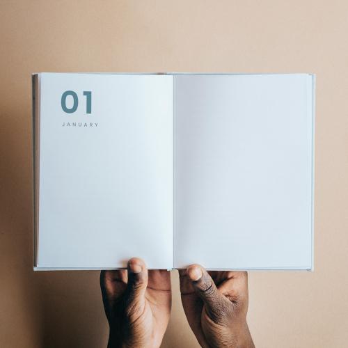 Black man holding a book planner mockup - 1213848