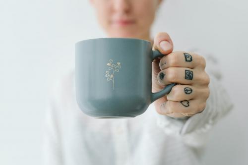 Smiling tattooed woman having a cup coffee mockup - 1215251