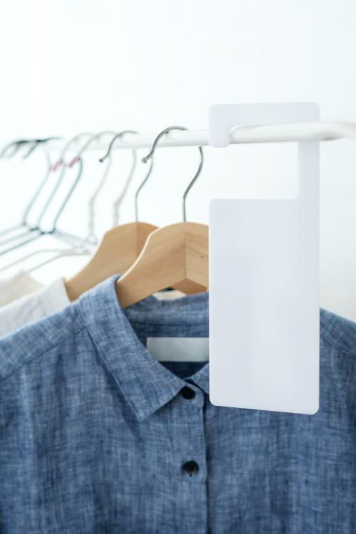 Shirt on a clothing rack with a tag mockup in a studio - 1215346