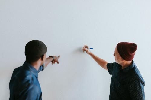 People writing on a white wall mockup - 1220180