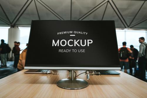 Computer screen mockup on a wooden table at the airport - 1221338