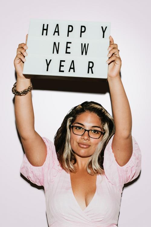 Woman with glasses raising happy new year board mockup - 1225174