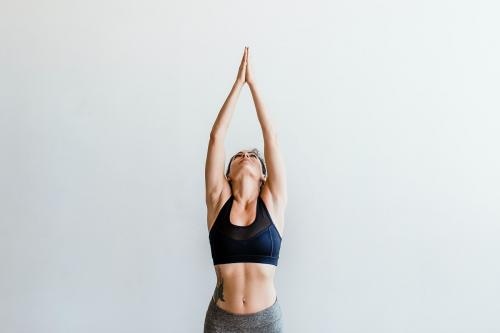 Sportive woman doing a Vriksasana pose - 1225588