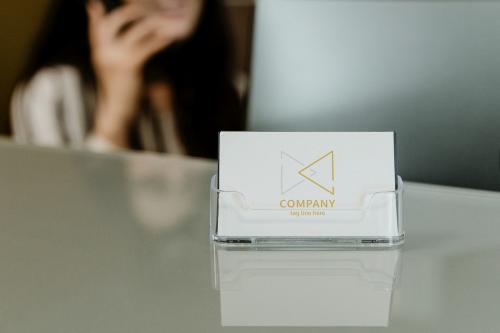 Receptionist sitting by the company name card - 1202303