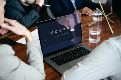 Business people using a laptop screen mockup in a meeting - 1208654