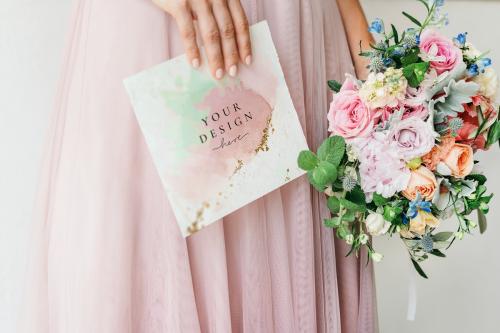 Bride holding a card mockup with a bouquet of flowers - 1209943