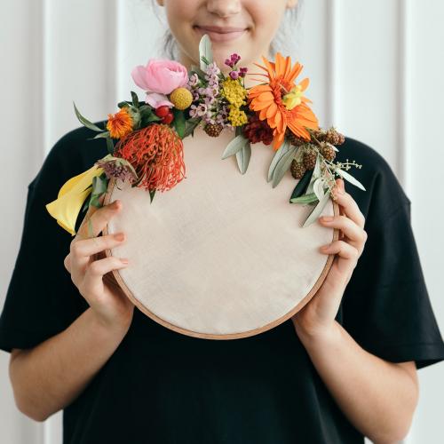 Happy woman holding a wooden frame mockup - 1210192