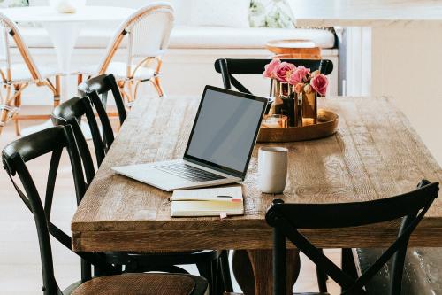 Notebook on a wooden dining table - 1211327