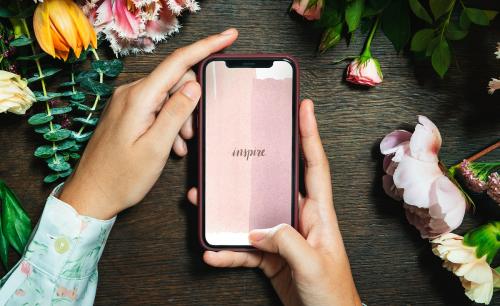 Woman holding with an inspire on a mobile screen mockup - 1212442