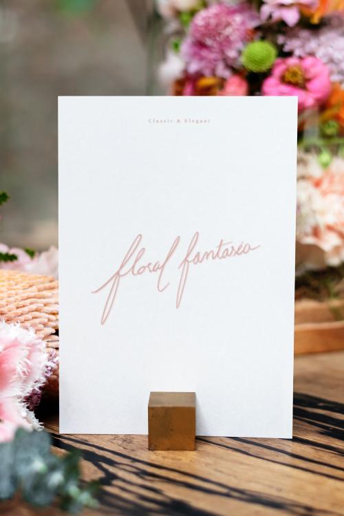 Card mockup by bouquet of flowers on a wooden table - 1212483