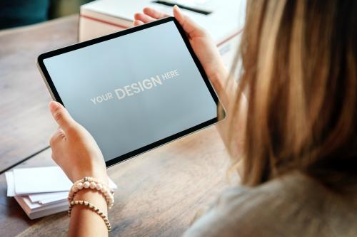 Woman holding a digital tablet mockup - 2027086