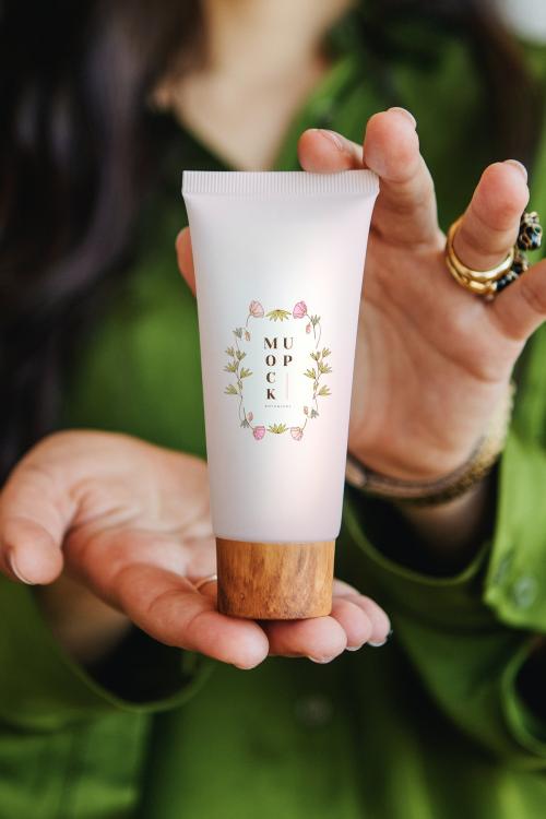 Woman holding lotion with both hands mockup - 2030375