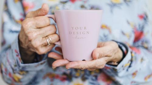 Woman holding a pink mug mockup illustration - 2030381