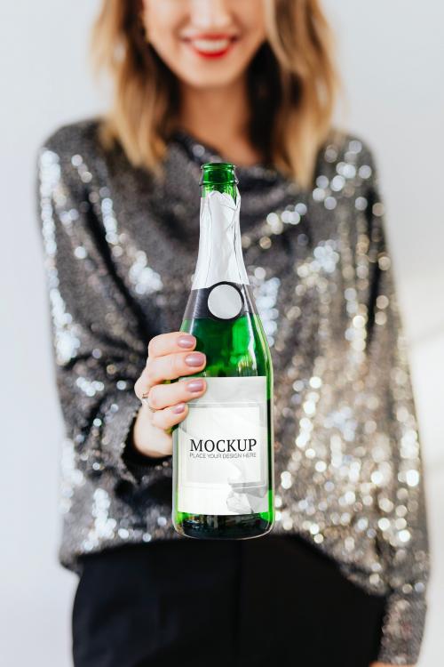 Woman holding a champagne bottle mockup - 2035759