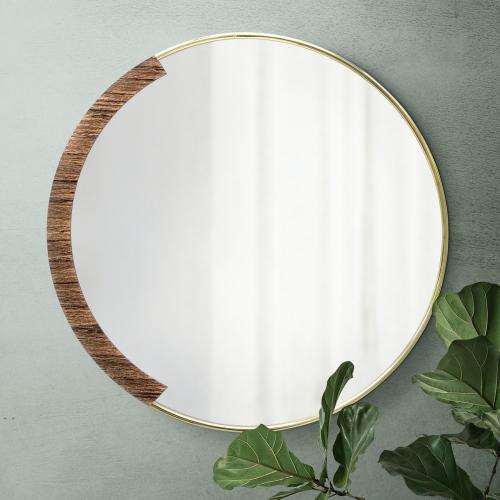 Circular mirror with a wooden backdrop mirroring fiddle-leaf fig on a green wall mockup - 2036826