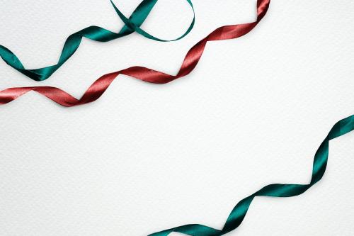 Green and red ribbons decorated on design space background - 2041192