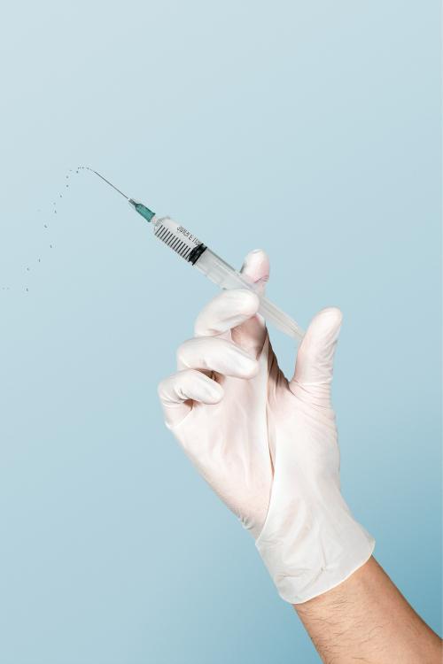 Hand wearing a white glove holding a syringe mockup - 2052986