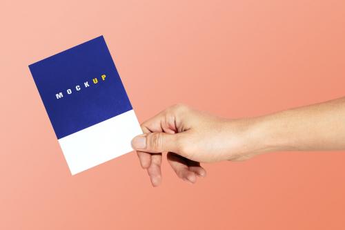 Hand holding a paper psd mockup - 2054371