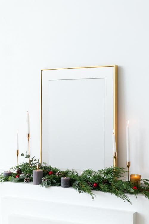 Festive golden photo frame against a white wall - 1231300