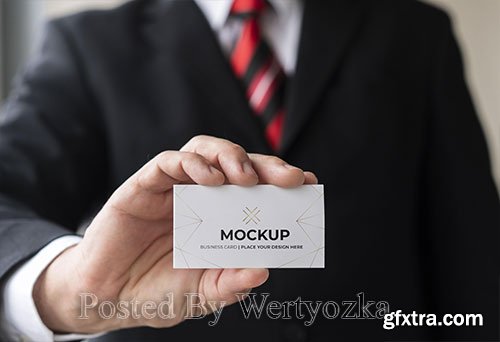 Close-up businessman holding business card mock-up with one hand