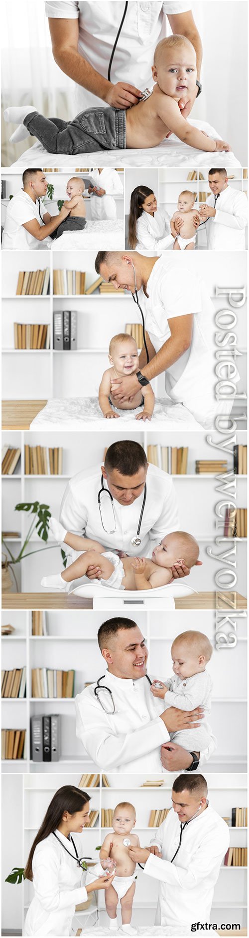 Doctor hands listening little baby stock photo