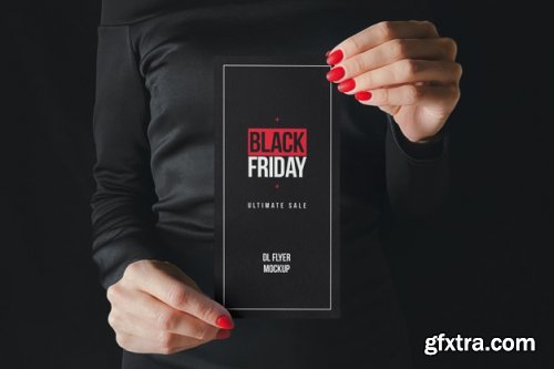 Woman in black holding paper mockup 