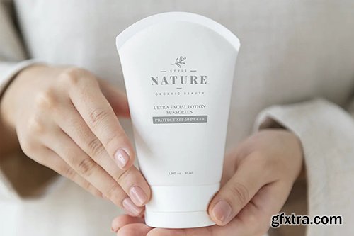 Woman holding a facial cream tube mockup