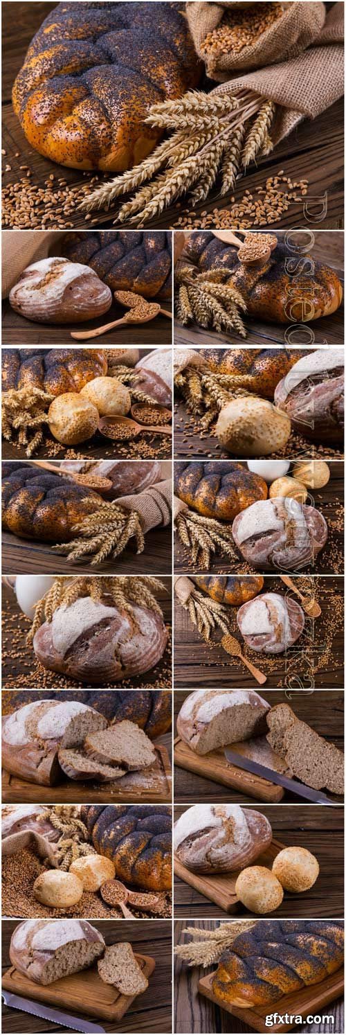 Wheat spikelets and fresh bread on wood background stock photo