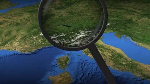 Videohive - Magnifying Glass Finds Genoa City on the Map - 32356443 - 32356443