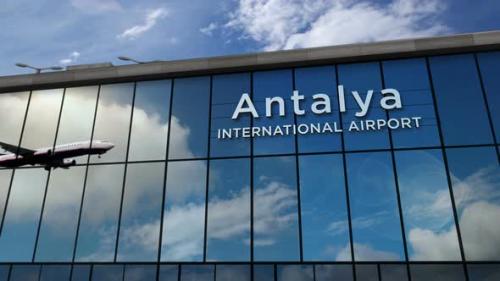 Videohive - Airplane landing at Antalya Turkey airport mirrored in terminal - 32359697 - 32359697