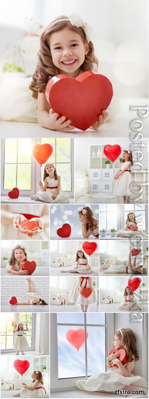 Smiling girl with red heart stock photo