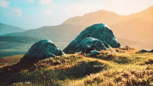 Videohive - Meadow with Huge Stones Among the Grass on the Hillside at Sunset - 32496675 - 32496675